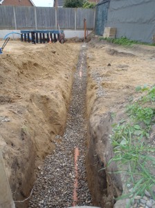 Sewage pipe in trench bedded with gravel