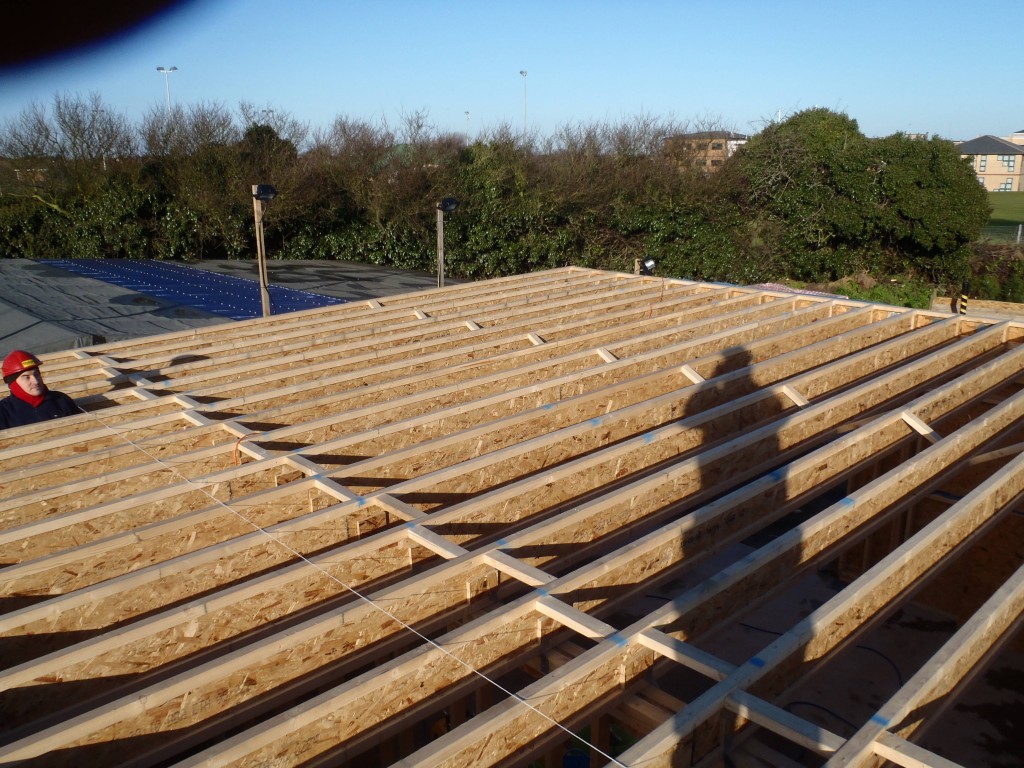 Starting to cover the roof rafters