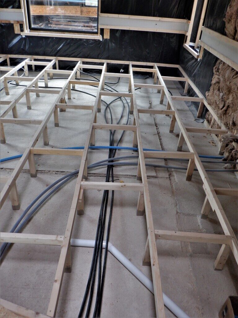 Part Two of Great Room Floor Construction with Air, Sensors and Water Installed and Floorboards Laid but not Fixed